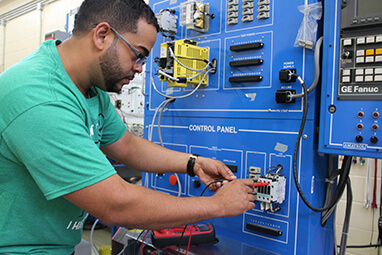 Advanced Manufacturing student at control panel